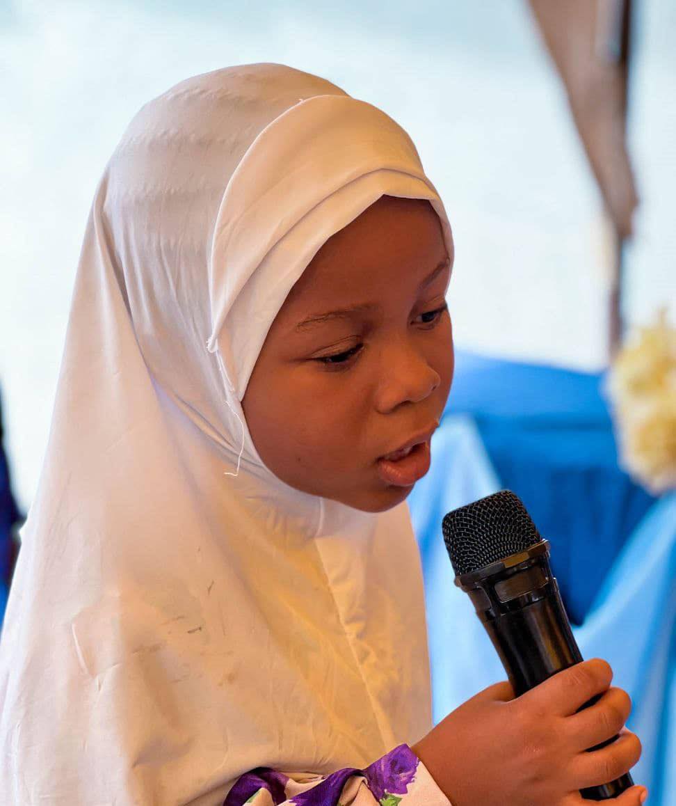 A pupil speaking into a microphone
