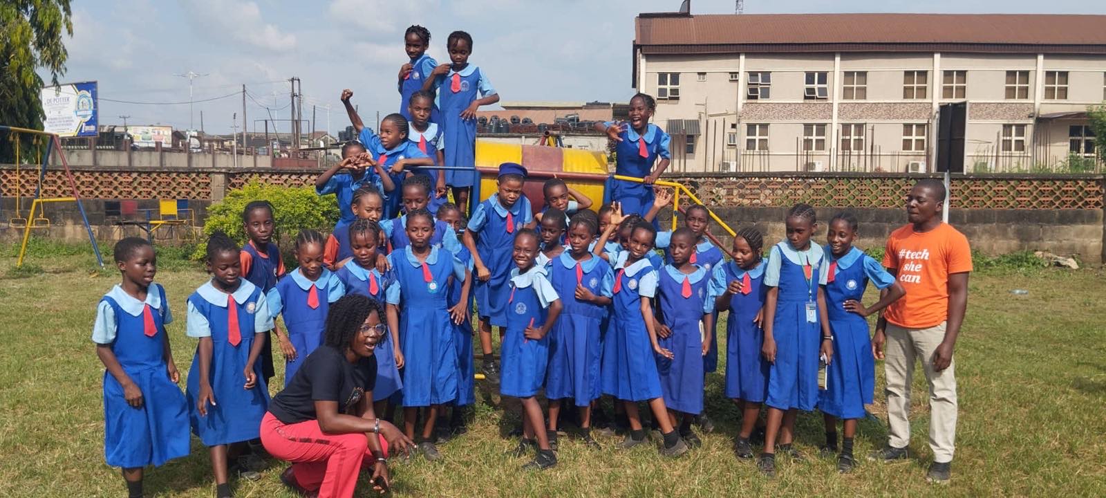 Pupils in blue uniforms gathered on the school playground