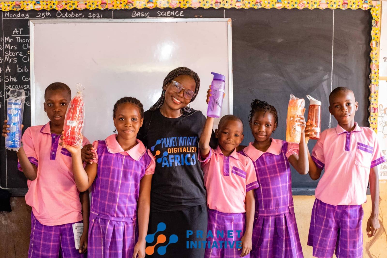 Pupils and a volunteer holding up what they made