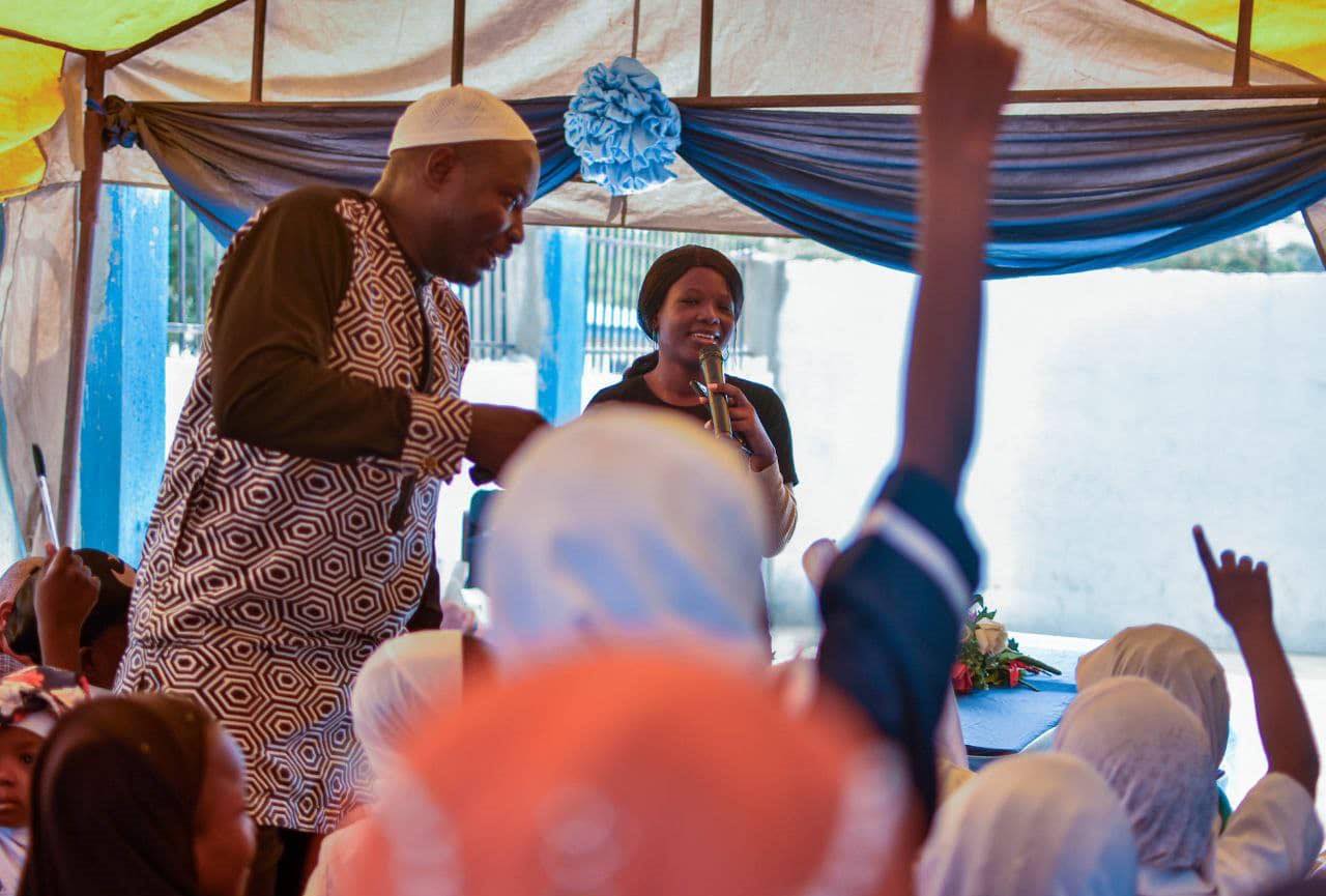 A speaker addressing pupils at a school event